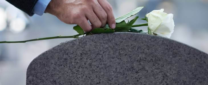 grave with white flower on top