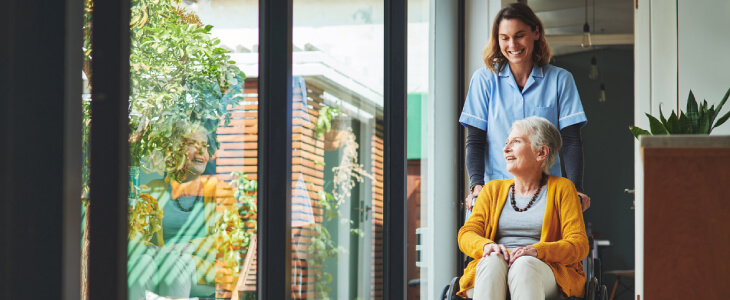 elderly woman in wheelchair with nurse