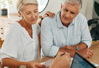 an older couple looking over documents